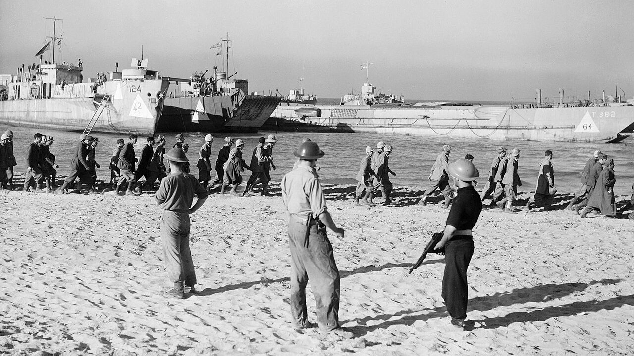 Italian POWs march to waiting landing craft during the Allied invasion of Sicily, July 1943